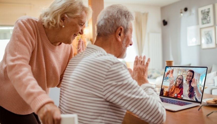 two older adults using zoom on a laptop